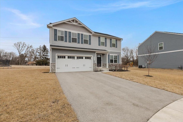 craftsman house featuring driveway, a garage, central AC unit, stone siding, and a front yard