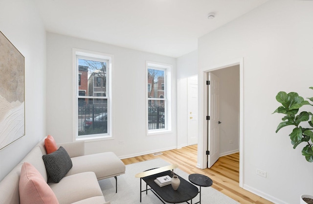 living room featuring baseboards and light wood finished floors