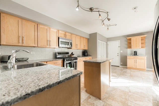 kitchen with stainless steel appliances, open shelves, a sink, a center island, and light brown cabinetry