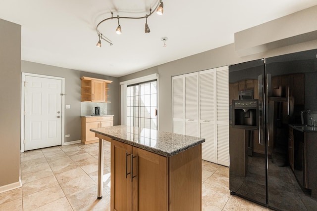 kitchen featuring light tile patterned floors, a sink, a center island, open shelves, and tasteful backsplash