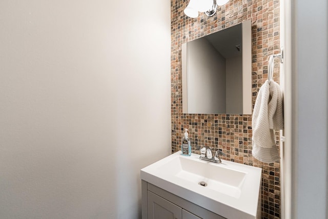 bathroom with tasteful backsplash and vanity