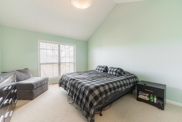 carpeted bedroom with vaulted ceiling and baseboards