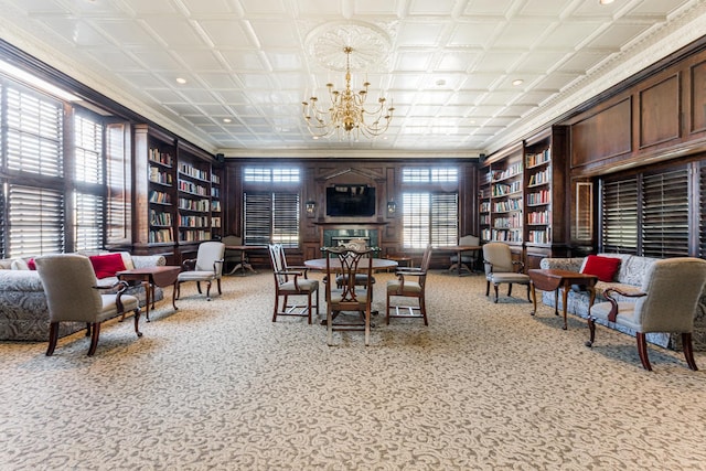 carpeted dining area featuring an ornate ceiling, a wealth of natural light, built in features, and an inviting chandelier