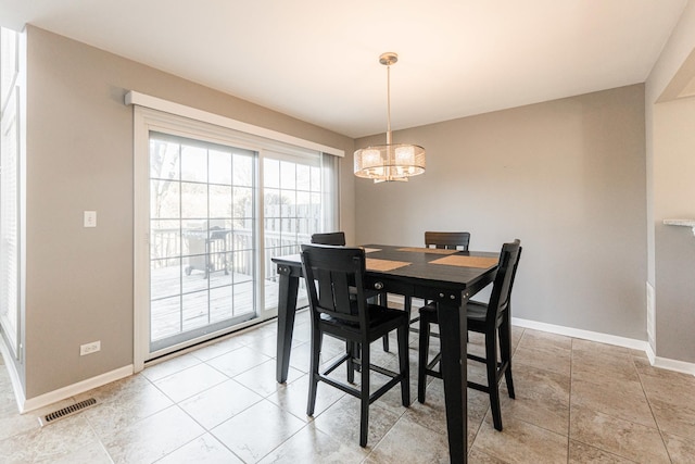 dining room with visible vents, baseboards, and an inviting chandelier