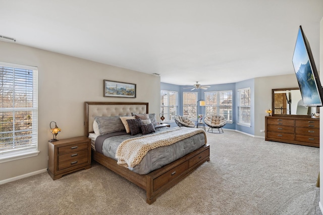 bedroom with baseboards, visible vents, and light colored carpet