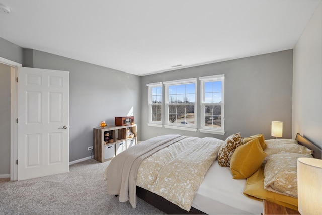 bedroom featuring carpet floors, visible vents, and baseboards