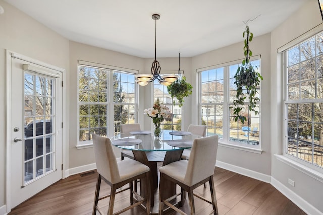 dining room with plenty of natural light, visible vents, and dark wood-type flooring