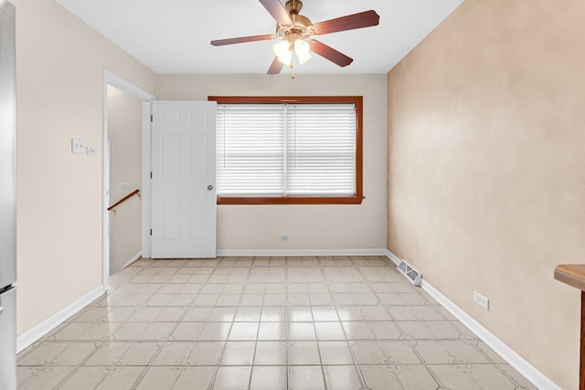 empty room featuring ceiling fan, light floors, visible vents, and baseboards