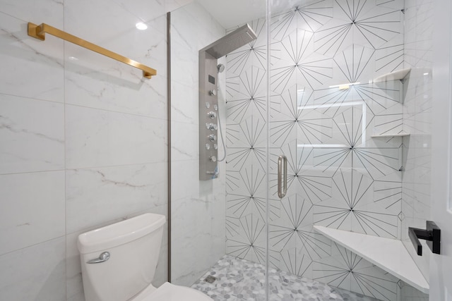 full bath featuring tile walls, a shower stall, and toilet