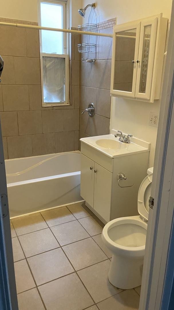 bathroom with toilet, vanity, tile patterned flooring, and washtub / shower combination