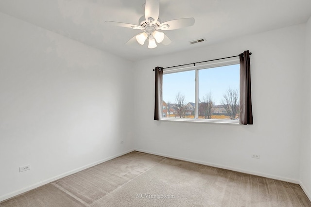 spare room featuring light carpet, baseboards, and visible vents