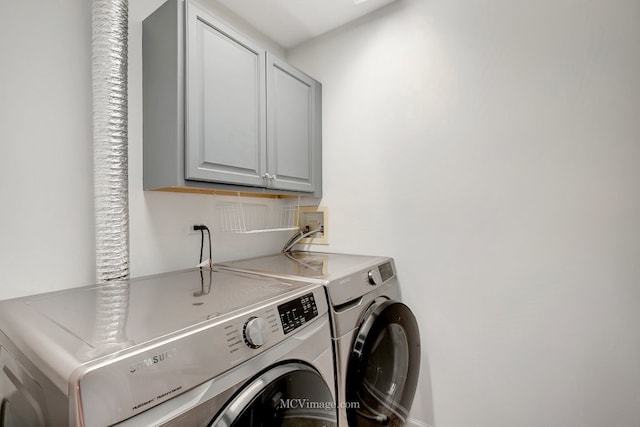 laundry area with cabinet space and independent washer and dryer