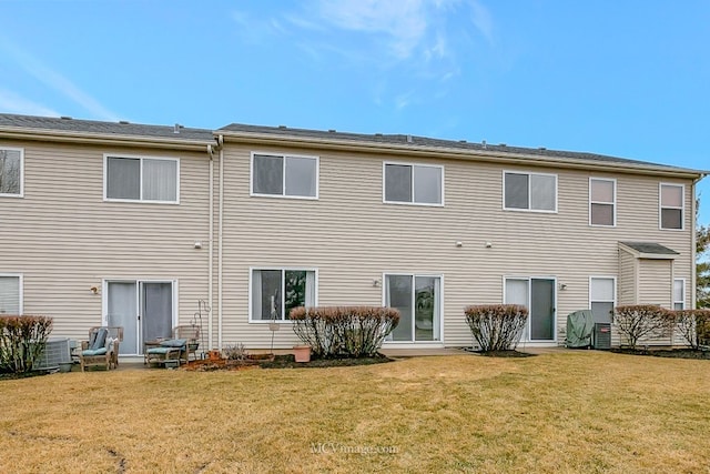 rear view of house with a yard