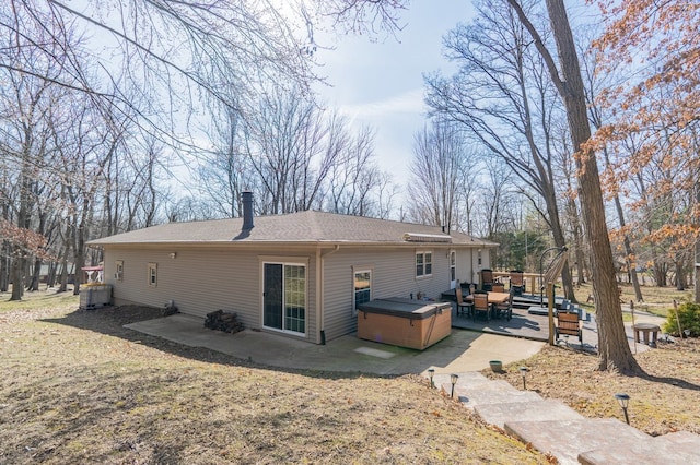 back of house with a patio, central AC unit, and a hot tub