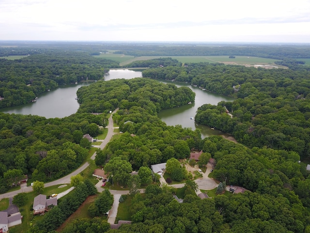 bird's eye view featuring a wooded view and a water view