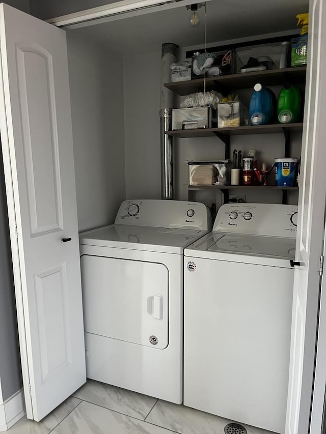 laundry area with marble finish floor, laundry area, and washing machine and clothes dryer