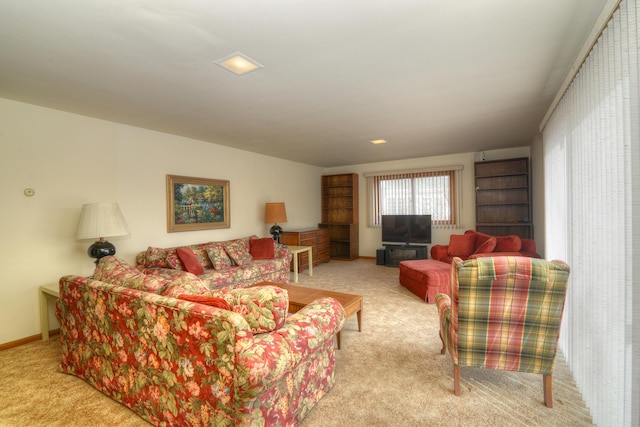 living area with baseboards and carpet flooring