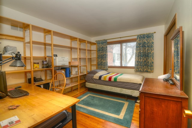 bedroom with visible vents and wood finished floors