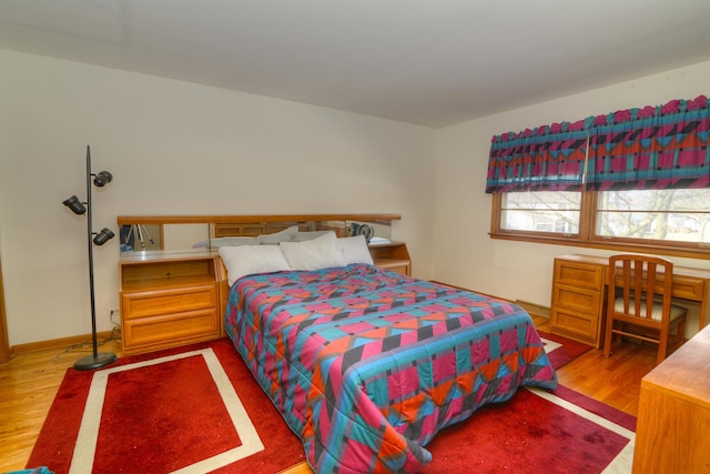 bedroom with wood finished floors and baseboards