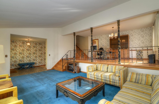 carpeted living room with a notable chandelier, stairway, wallpapered walls, and vaulted ceiling