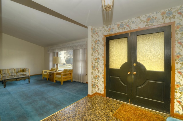 carpeted entrance foyer featuring french doors, baseboards, vaulted ceiling, and wallpapered walls