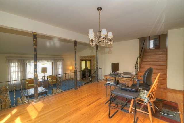 dining space with stairs, an inviting chandelier, and wood finished floors