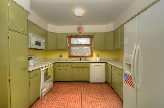 kitchen with a sink, white appliances, green cabinets, and light countertops