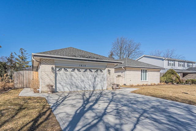 view of front of house featuring driveway, brick siding, a shingled roof, an attached garage, and a front yard