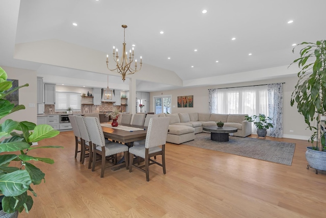 dining area featuring light wood-type flooring, an inviting chandelier, a wealth of natural light, and recessed lighting