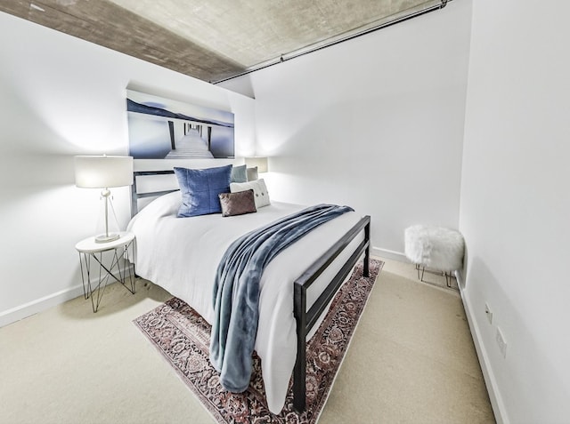 carpeted bedroom featuring baseboards