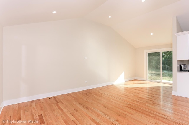 unfurnished living room with light wood-style flooring, baseboards, vaulted ceiling, and recessed lighting