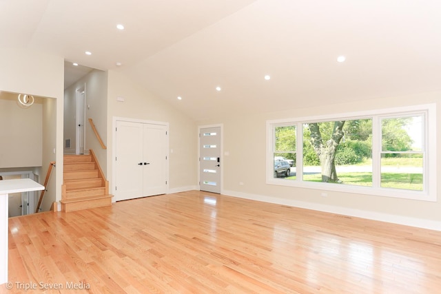 unfurnished living room featuring light wood-type flooring, stairway, baseboards, and recessed lighting