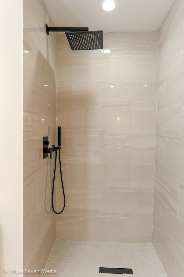 full bath with a tile shower