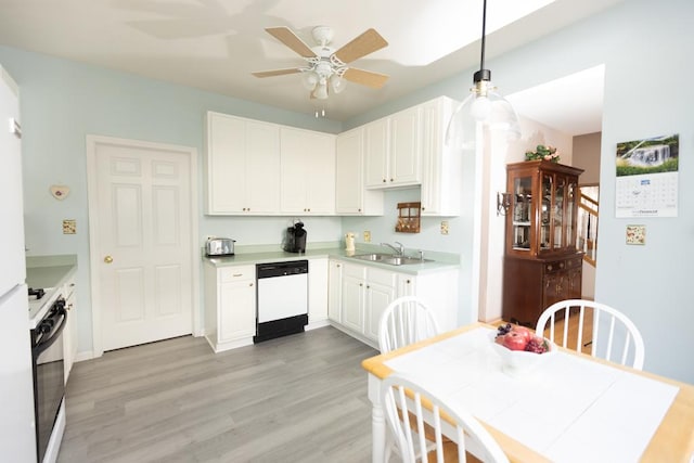 kitchen with range with gas stovetop, white dishwasher, light wood-type flooring, white cabinetry, and a sink