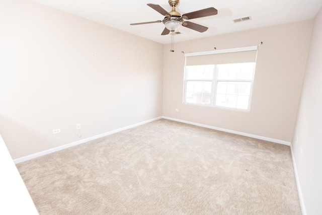 empty room featuring carpet floors, baseboards, visible vents, and ceiling fan