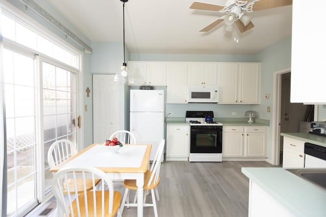 kitchen featuring white appliances, white cabinetry, light countertops, and light wood finished floors