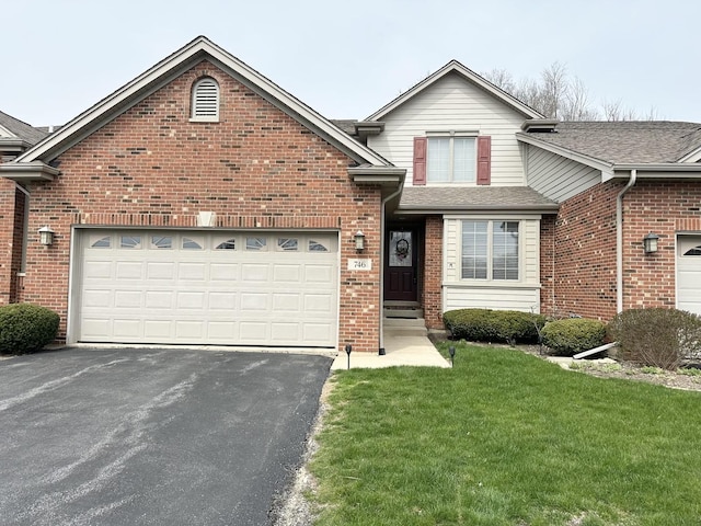 view of front of home with a front lawn, brick siding, an attached garage, a shingled roof, and driveway