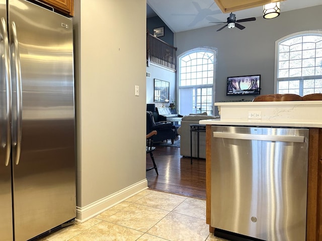 kitchen featuring plenty of natural light, light countertops, a ceiling fan, and appliances with stainless steel finishes