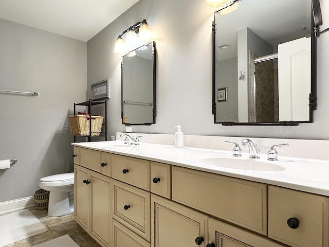 bathroom featuring a sink, toilet, double vanity, and a stall shower