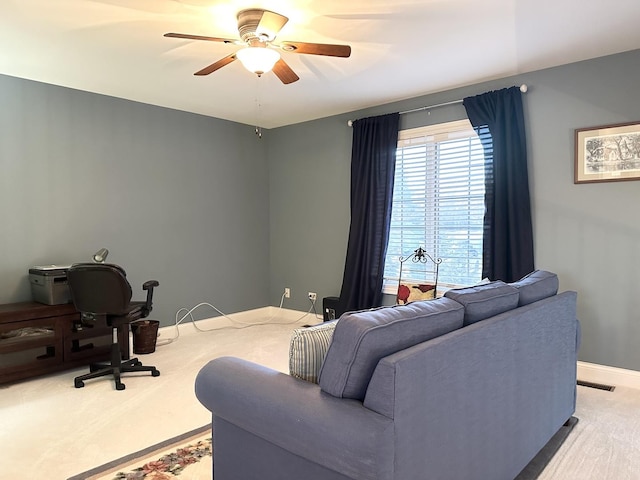office area featuring visible vents, baseboards, and a ceiling fan