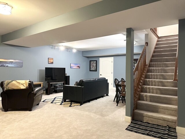 living room with carpet and stairs