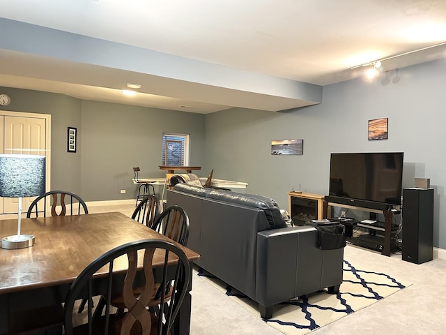 living area with light carpet and baseboards