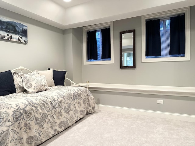 carpeted bedroom featuring baseboards
