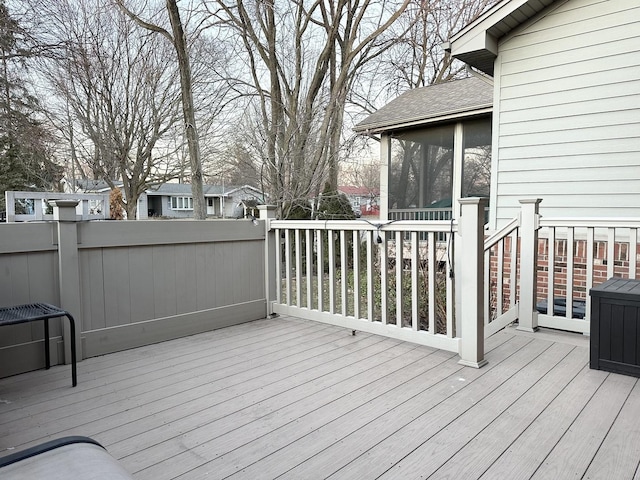 wooden deck featuring a sunroom