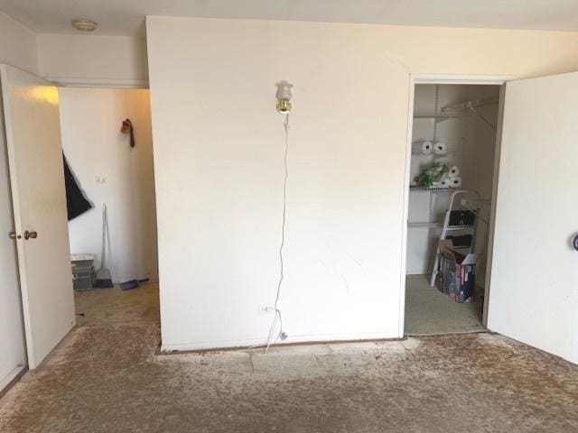 unfurnished bedroom featuring carpet floors and a closet