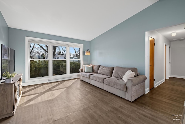 living room with baseboards, wood finished floors, and vaulted ceiling