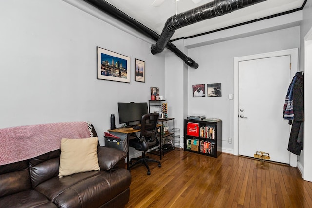 home office with baseboards and hardwood / wood-style floors