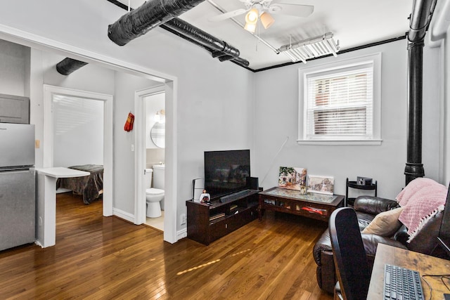 living area with a ceiling fan and hardwood / wood-style floors