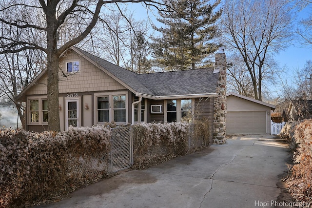 view of front of house with a garage, a shingled roof, a chimney, and fence