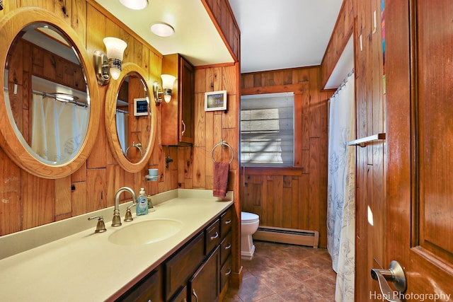 bathroom featuring a baseboard radiator, toilet, wooden walls, vanity, and tile patterned floors